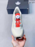 Top view of the sneaker showing the off-white upper, red mesh tongue area, BOA dial, and lace-support structure.