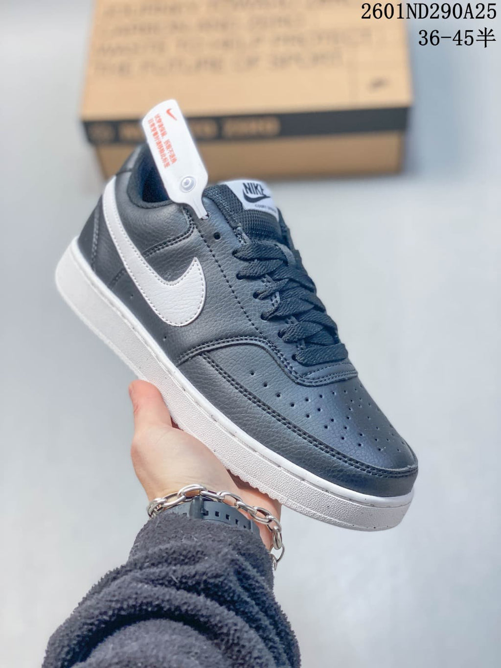 Close side view of the navy and white sneaker with lace-up construction and contrasting Swoosh.