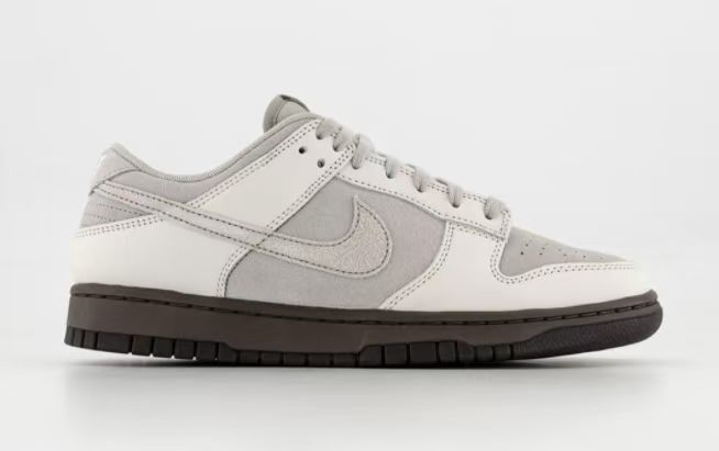 Side profile of the sneaker against a light background, showing the gray and off-white color blocking.