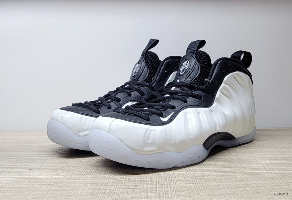 Angled front view of white and black Nike Little Posite One GS sneakers
