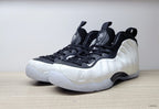 Angled front view of white and black Nike Little Posite One GS sneakers