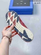 Close view of the sneaker outsole showing a contrasting tread pattern with dark rubber sections and a light central area.