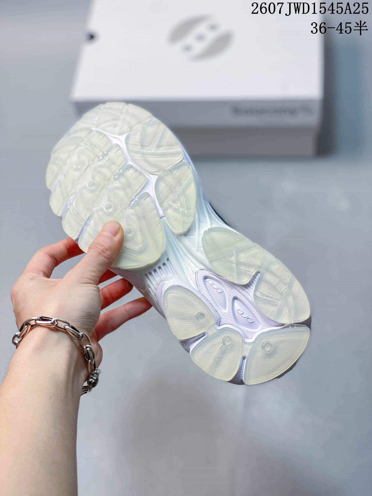 Underside view of a Saucony sneaker showing the segmented translucent outsole and white sole structure.