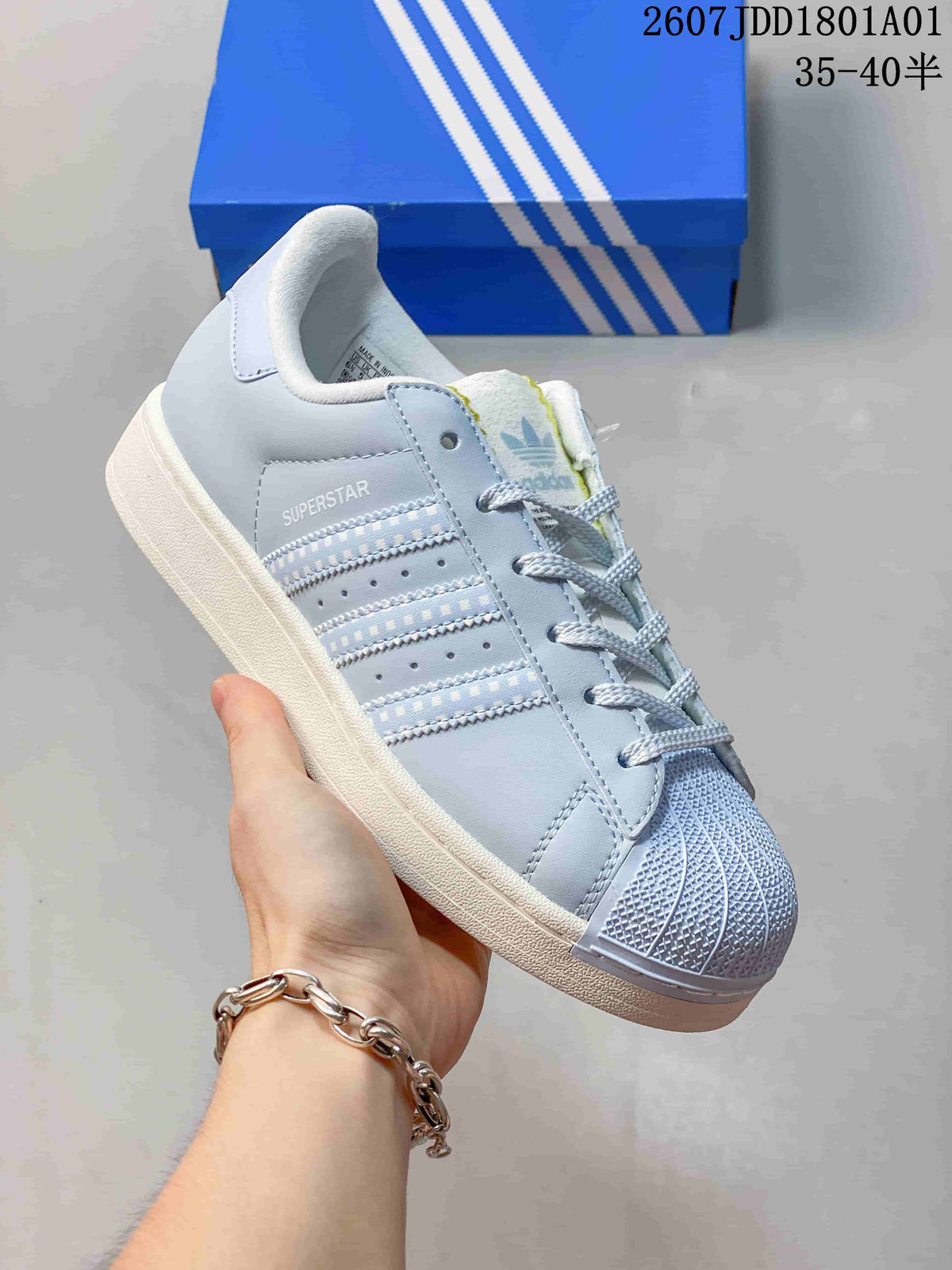 Close side view of the light blue Adidas Superstar sneaker