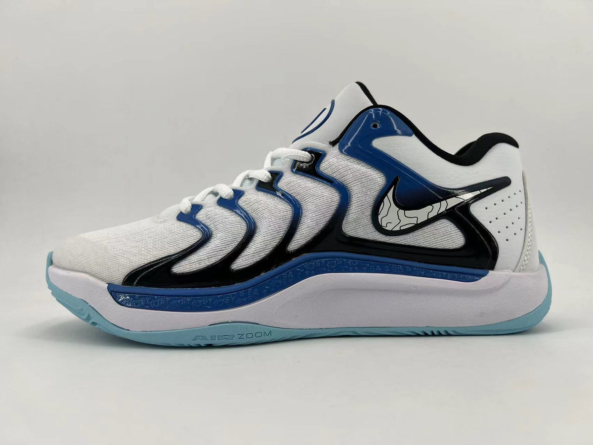 Side view of a white Nike basketball shoe with black and blue overlays, white laces, and a pale blue outsole.