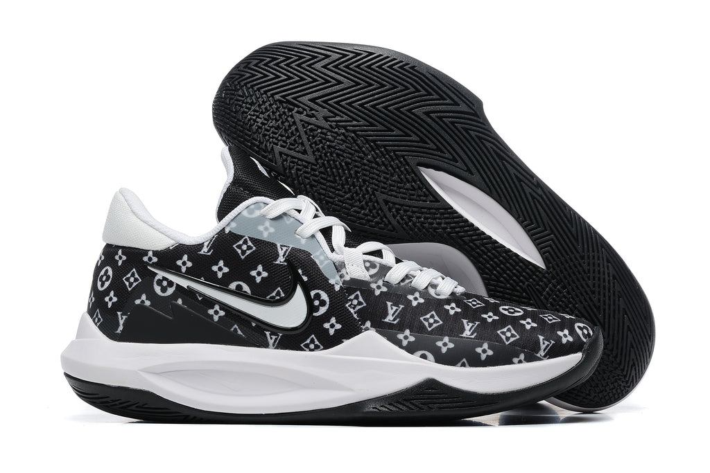 Black basketball shoe with white repeating monogram-style graphics and a black outsole.
