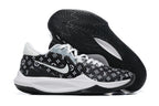 Black basketball shoe with white repeating monogram-style graphics and a black outsole.