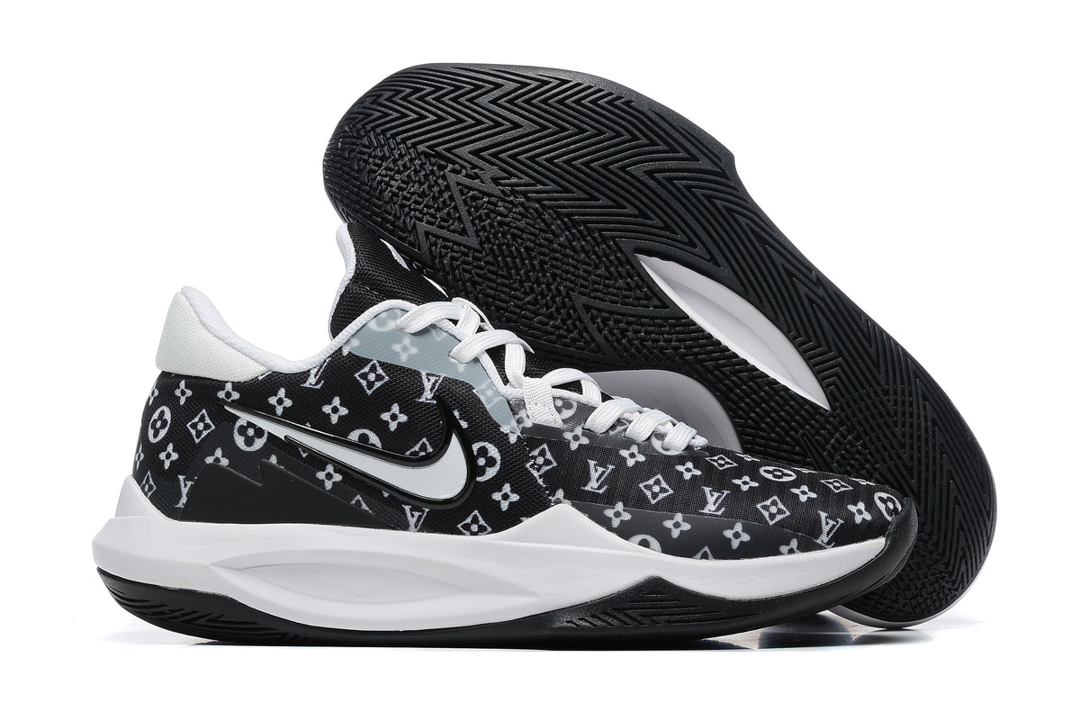 Black basketball shoe with white repeating monogram-style graphics and a black outsole.
