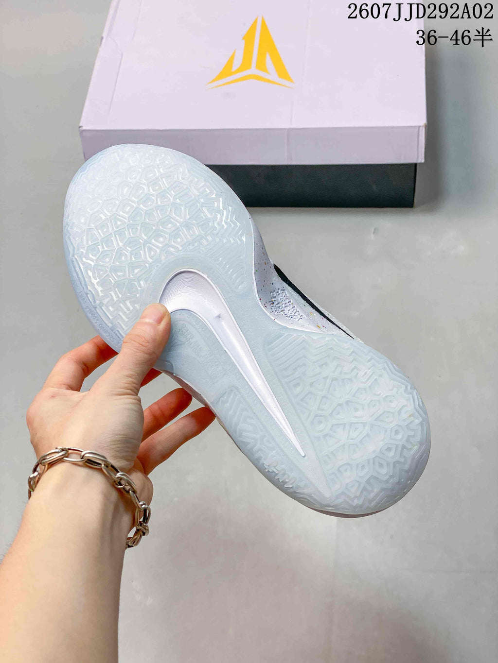 Bottom view of the shoe showing a translucent outsole with a geometric traction pattern.