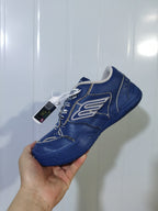 Angled view of the navy and taupe Balenciaga 4090 sneaker showing the layered side panels, laces, and padded collar.