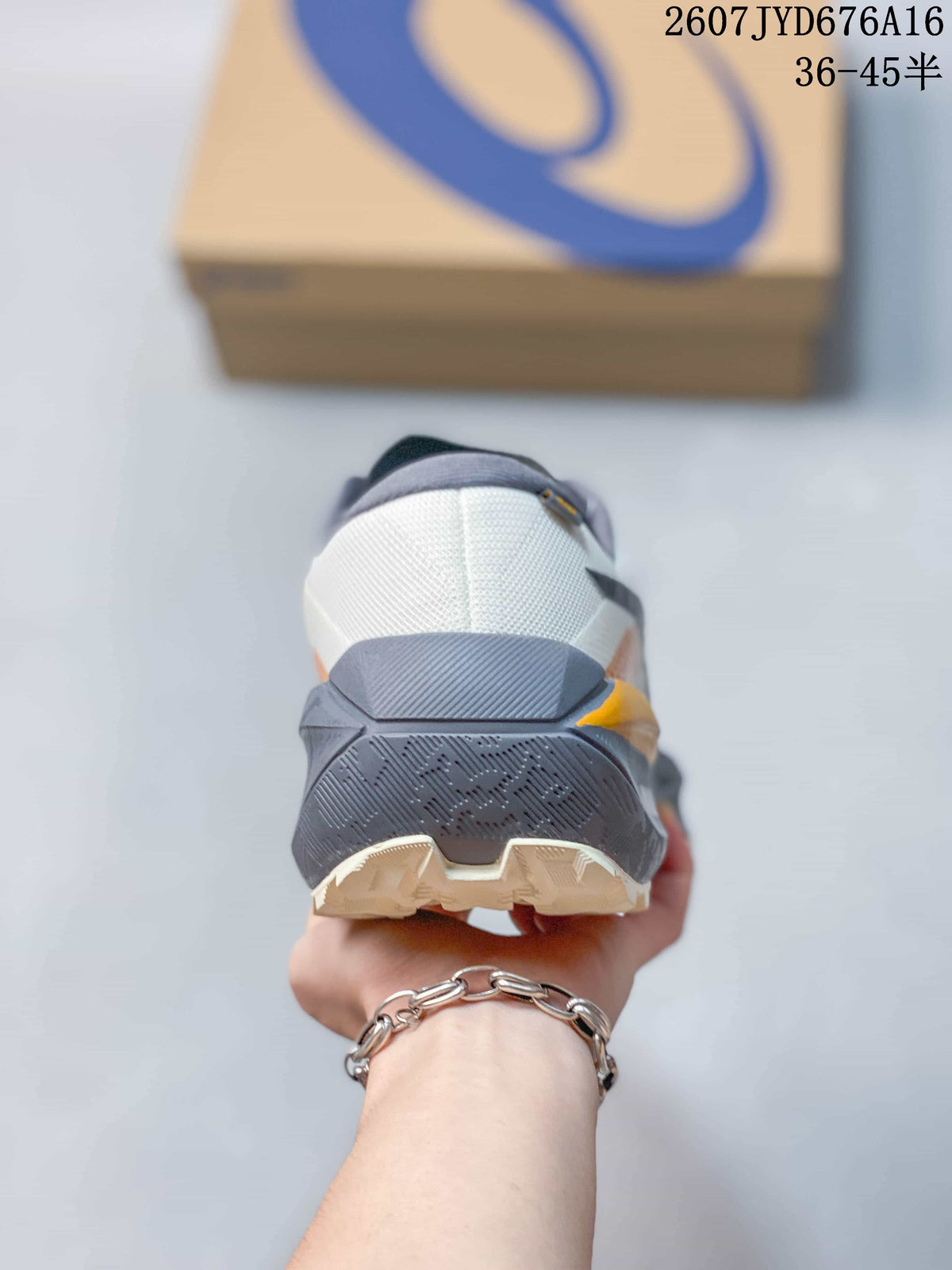 Rear view showing the padded heel, layered gray midsole, orange accent, and textured outsole.
