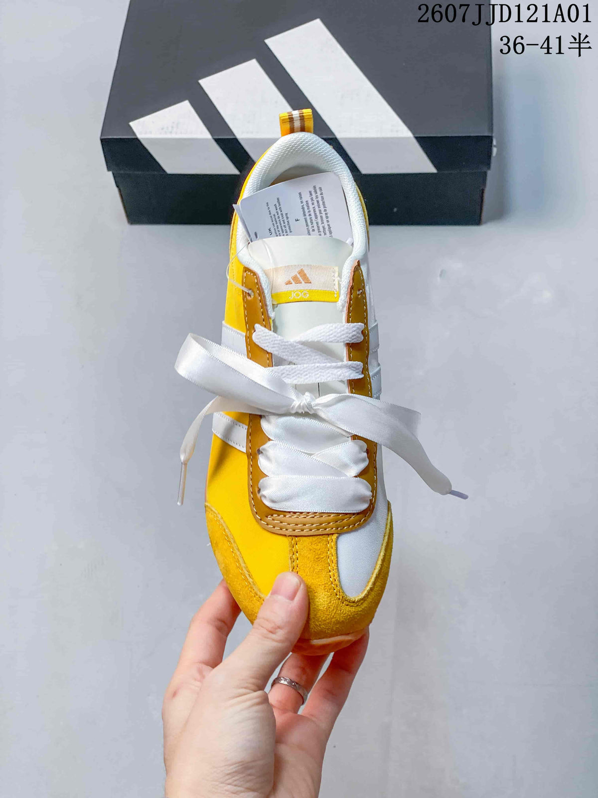 Top view of the yellow and white adidas VS JOG 2.0 sneaker with ribbon-style and standard laces.