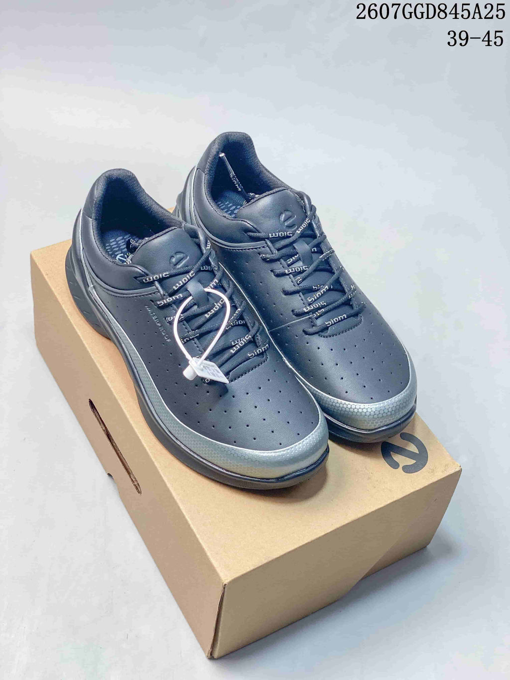 Pair of black ECCO Biom Energi low-top sneakers displayed on a shoebox, with silver-toned accents and the marked size range 39–45 visible above.