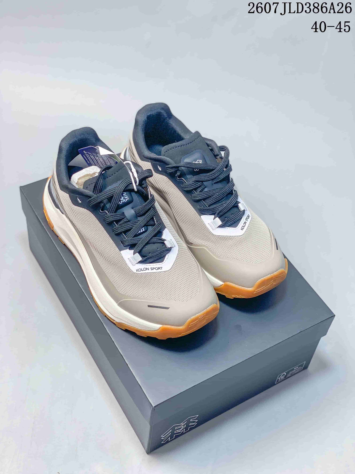 Pair of KOLON SPORT EGG LITE 2.0 outdoor shoes in gray, black and off-white with amber lugged outsoles, shown on a shoe box.