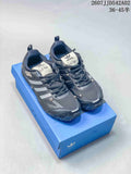 Pair of charcoal Adidas Adizero PR SFTM sneakers on a blue box