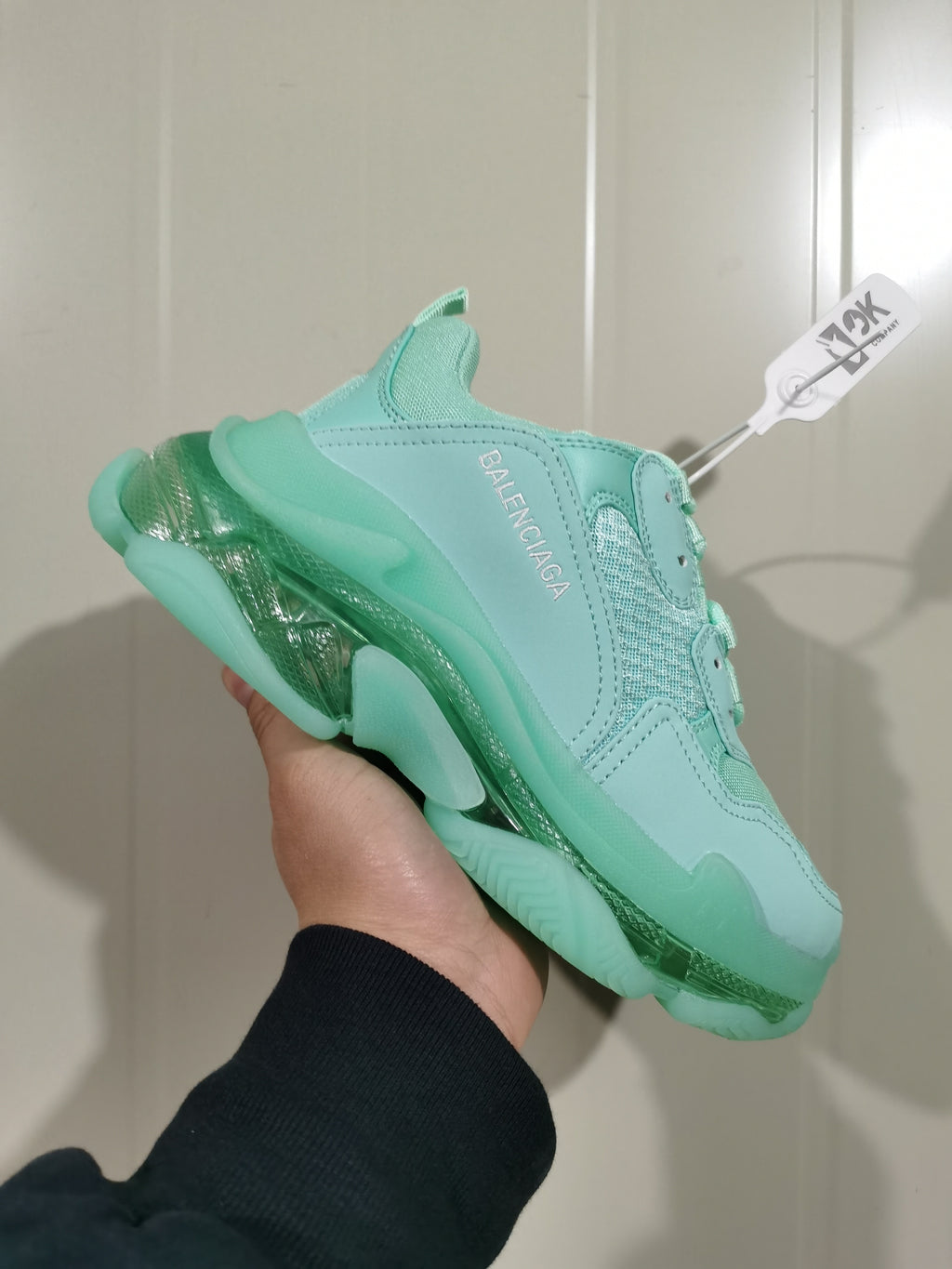 Angled close-up of the mint green Balenciaga sneaker showing the layered upper and translucent sole.