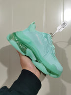 Angled close-up of the mint green Balenciaga sneaker showing the layered upper and translucent sole.