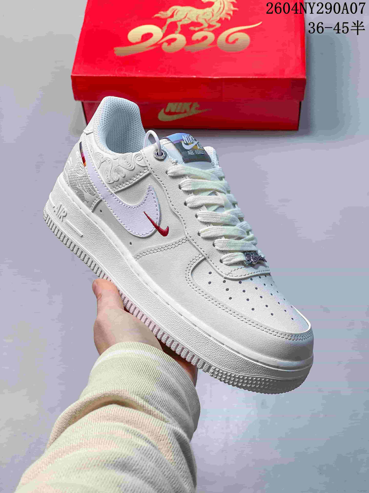 Close view of a white sneaker with embroidered details and contrasting swoosh accents