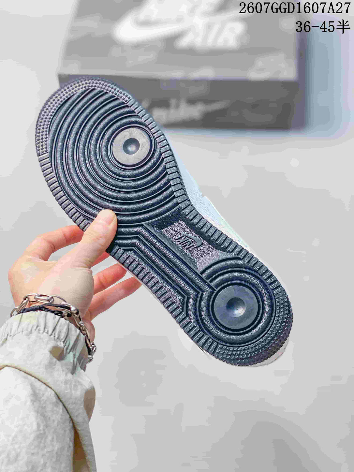 Close-up of the dark rubber outsole showing circular traction grooves and AIR branding.
