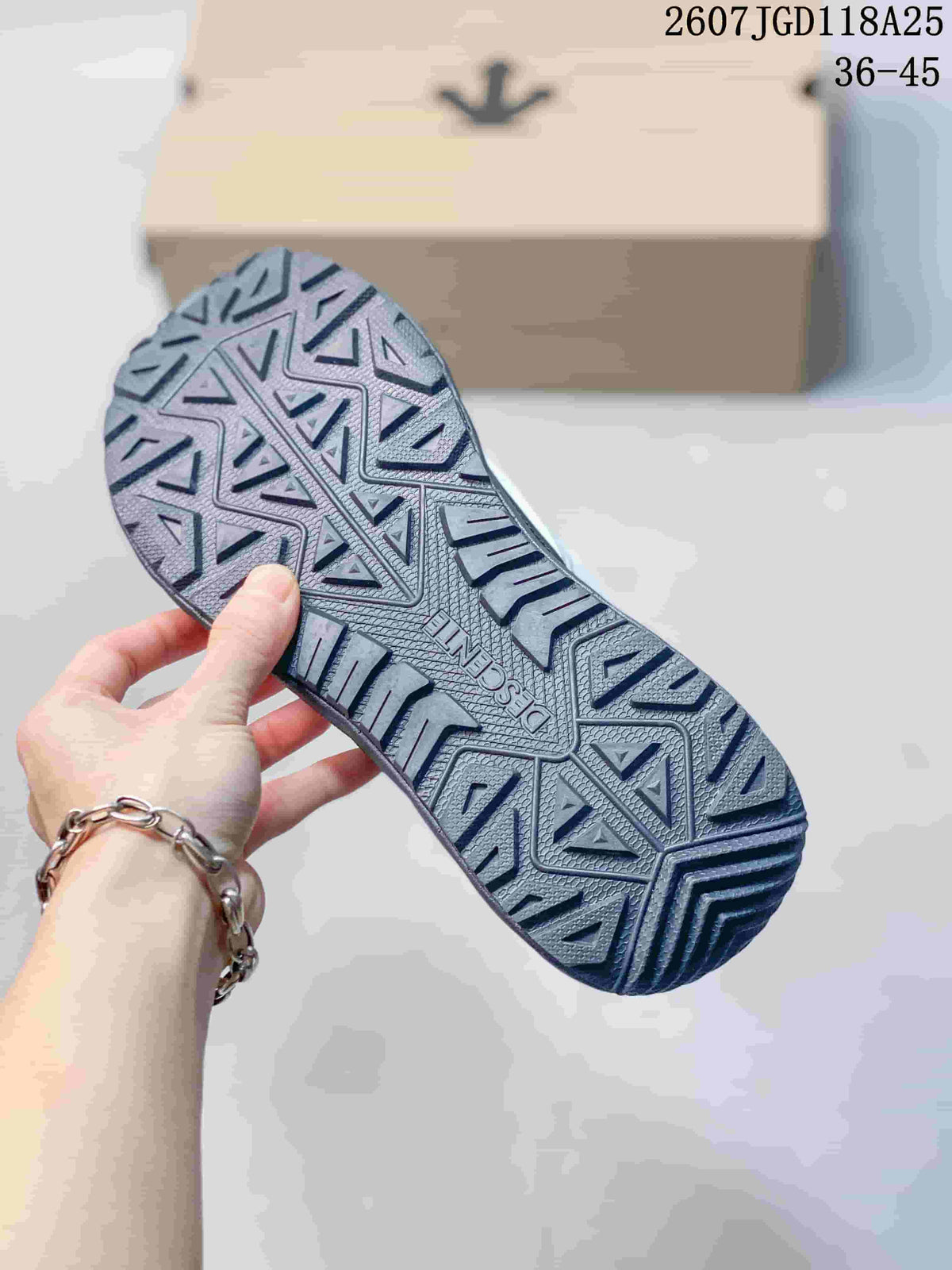 Close-up of the sneaker outsole showing a deep geometric tread pattern.