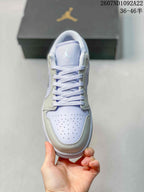 Top view showing white laces, a light lavender tongue, and perforated toe box.