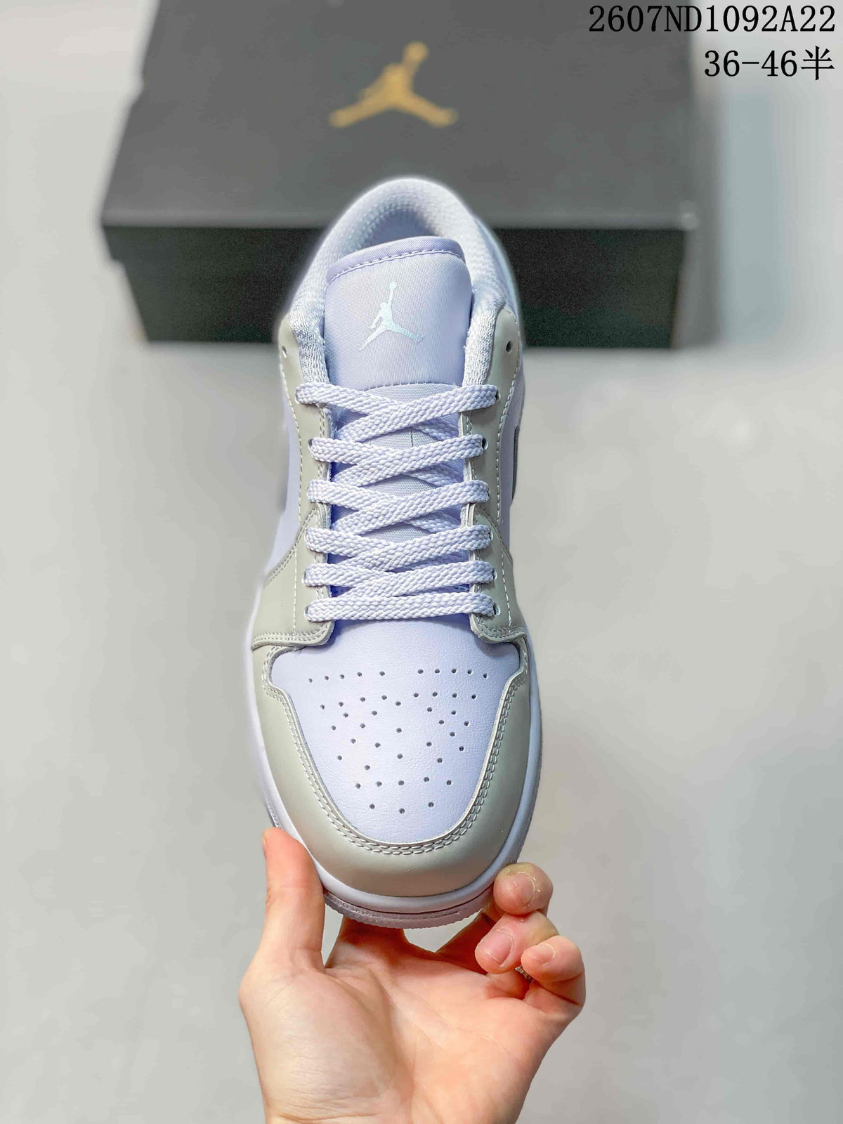Top view showing white laces, a light lavender tongue, and perforated toe box.
