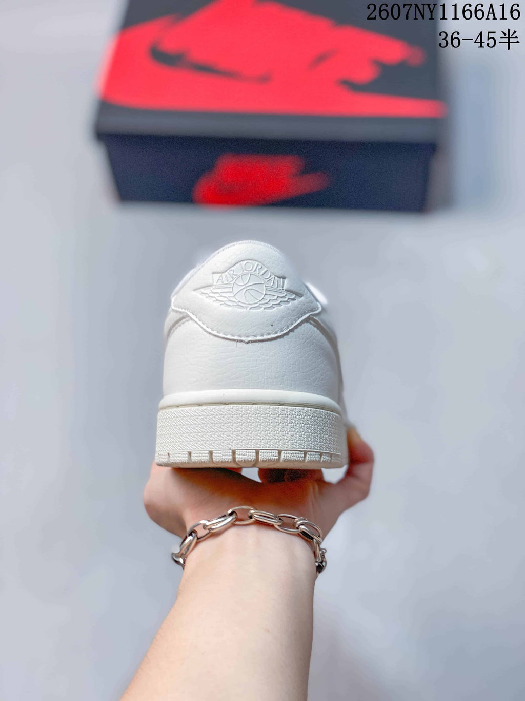 Rear view of a white low-top sneaker showing the Air Jordan Wings-style heel emblem, padded collar, and textured outsole.
