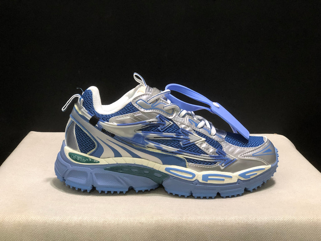 Outer side profile of one sneaker showing the arrow detail, lace system, and chunky blue outsole.