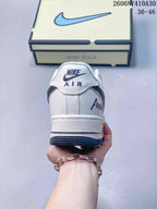 Rear view showing the heel branding and contrast outsole of the white sneakers
