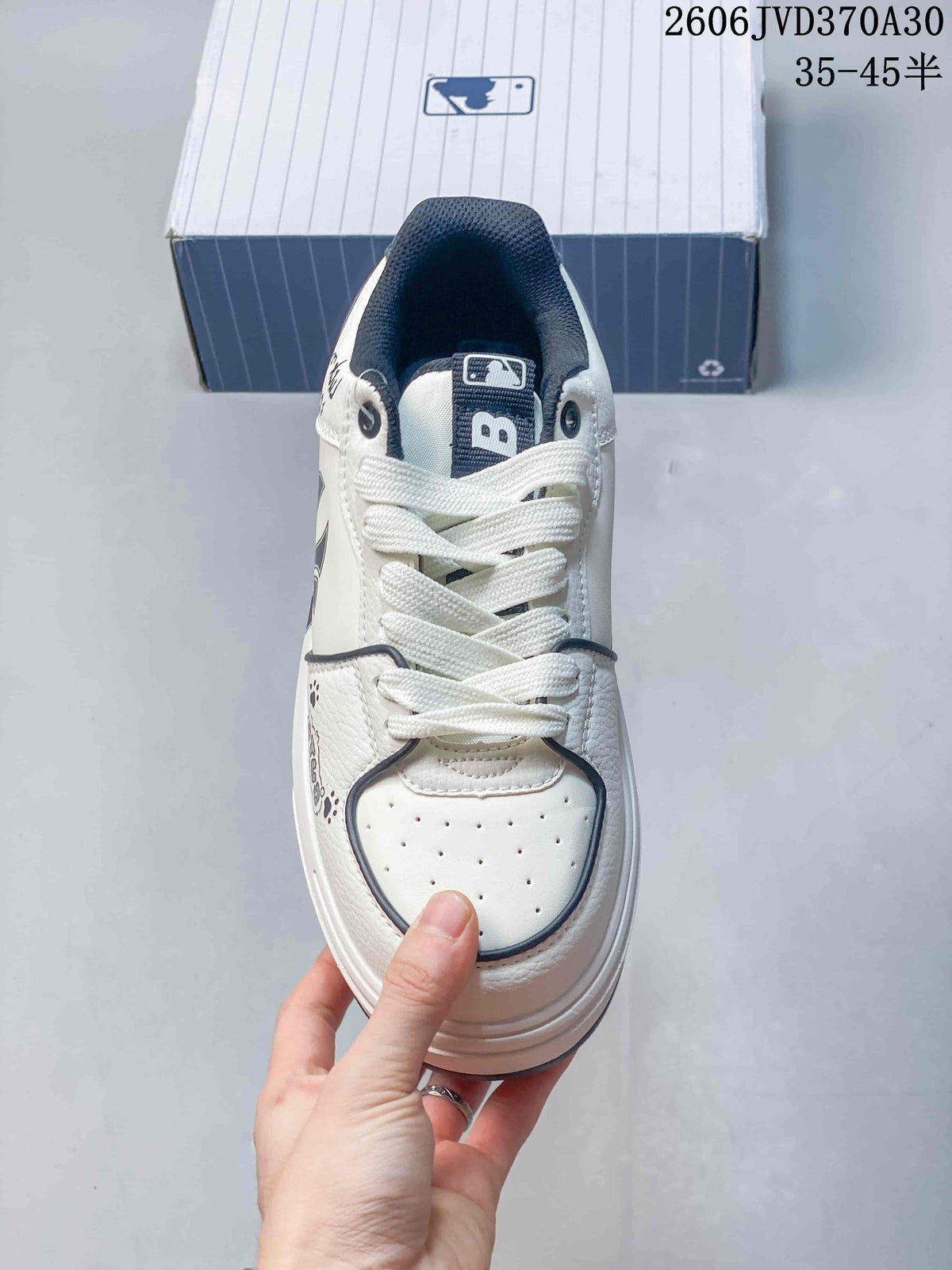 Top view showing the white laces, perforated toe panel, and dark tongue.