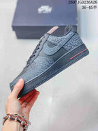 Side profile highlighting the low-top shape, patterned overlays, perforated side panel, and red midsole accent.