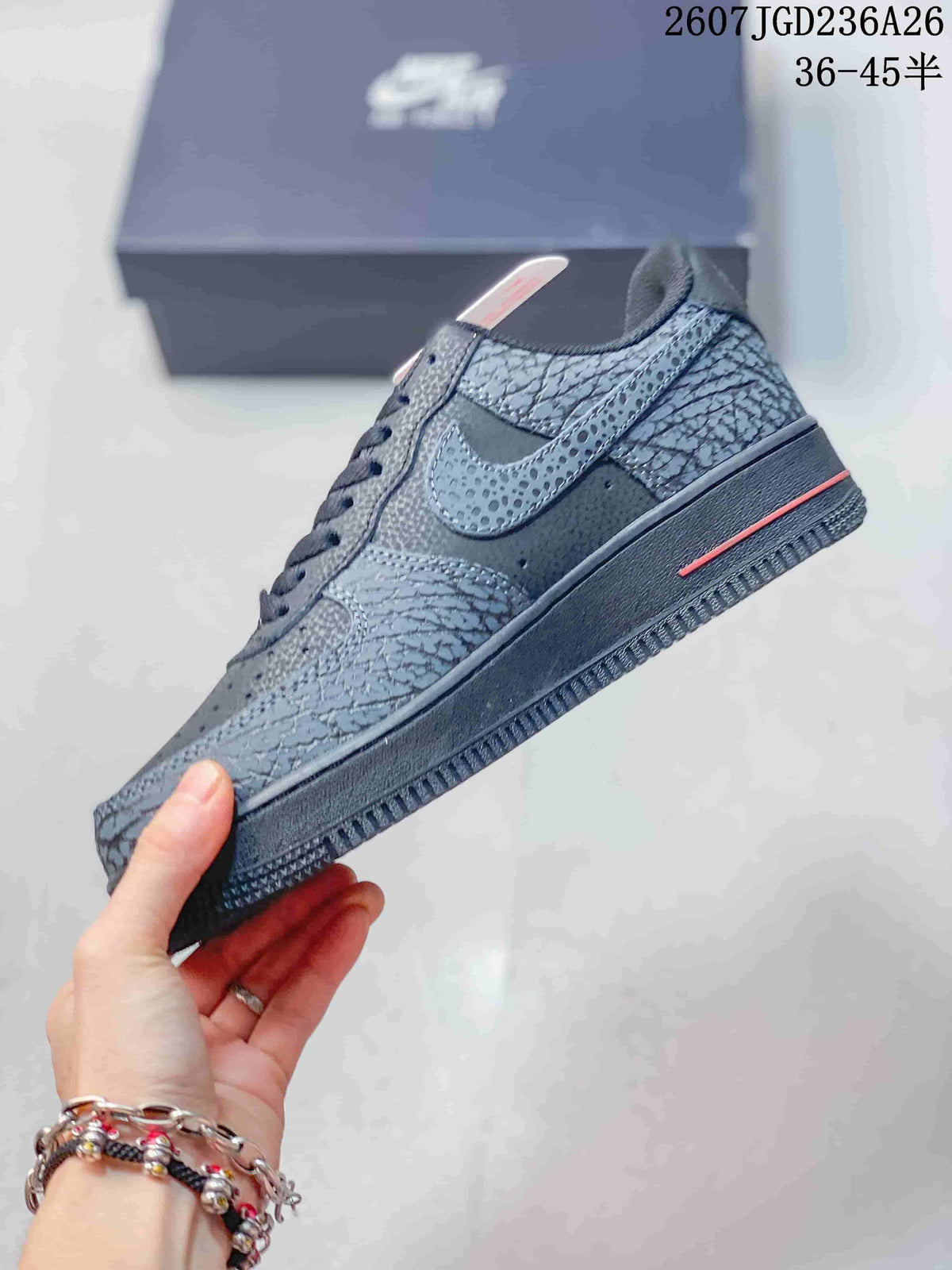 Side profile highlighting the low-top shape, patterned overlays, perforated side panel, and red midsole accent.