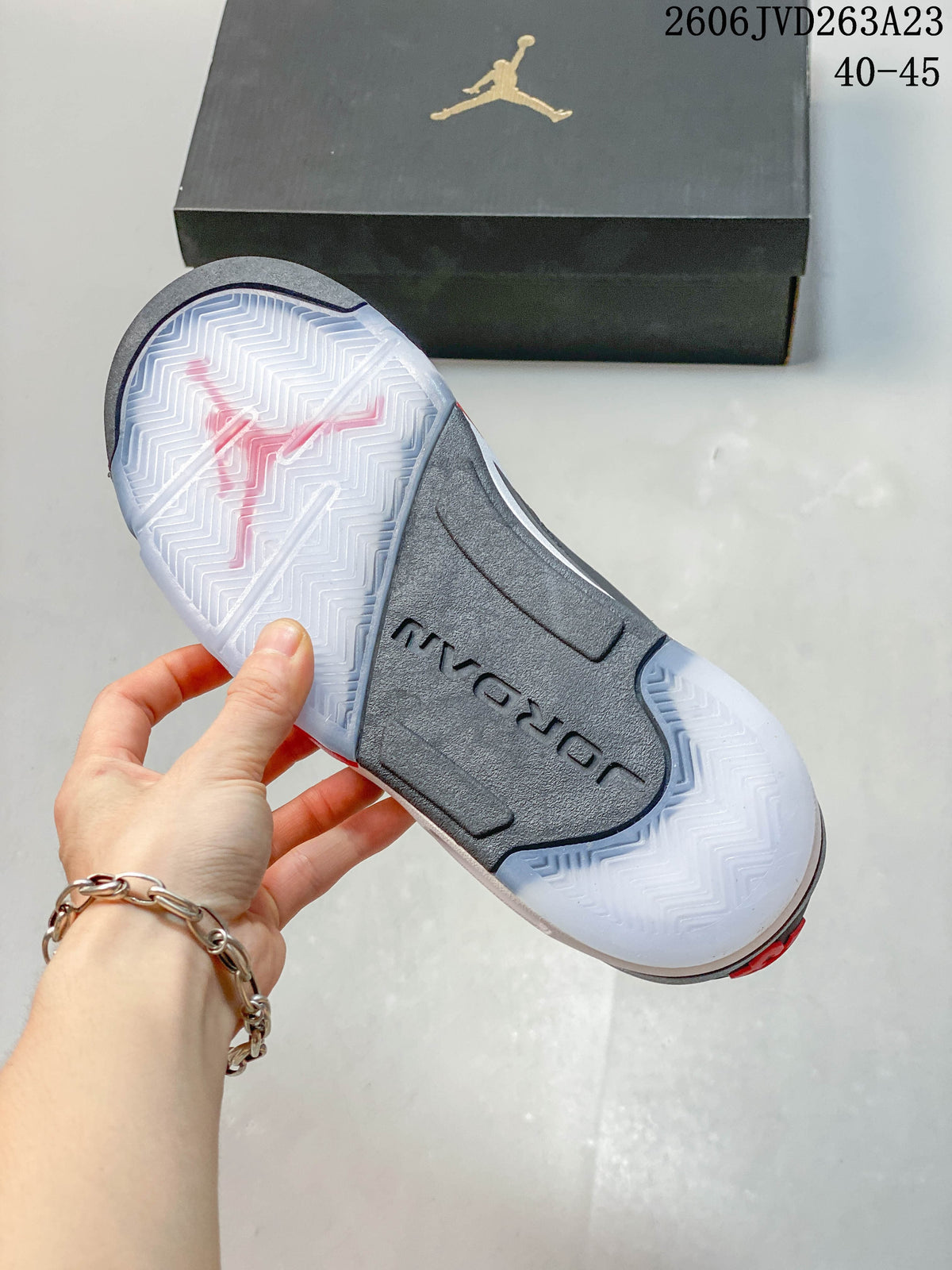 Underside of the sneaker showing a patterned outsole and central Jordan branding