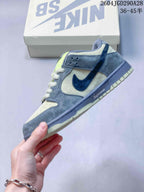 Side view of the low-top sneaker showing a dark blue Swoosh and grey panels