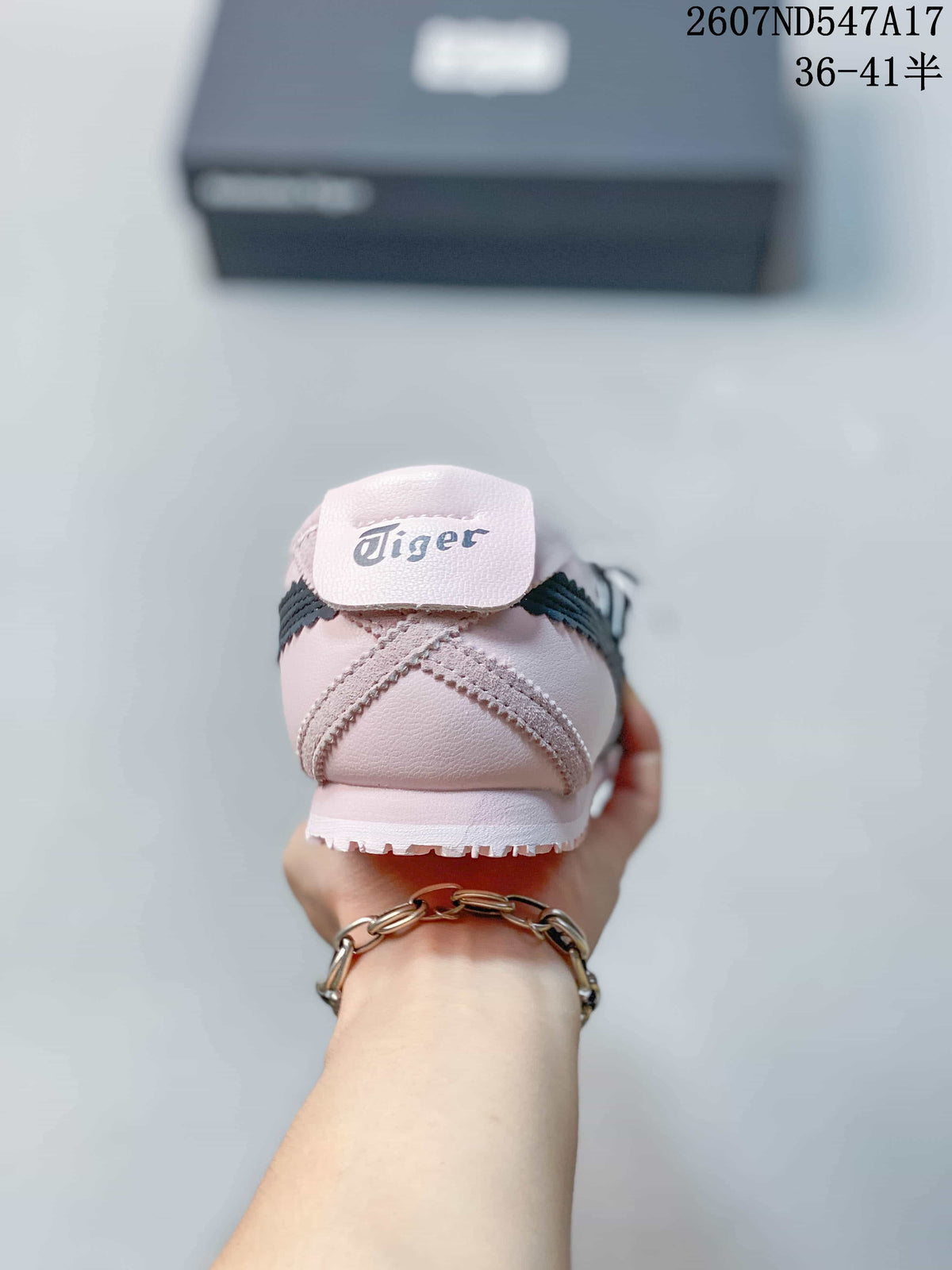 Rear view showing the Tiger-branded heel tab, pale pink upper, and dark side stripes.