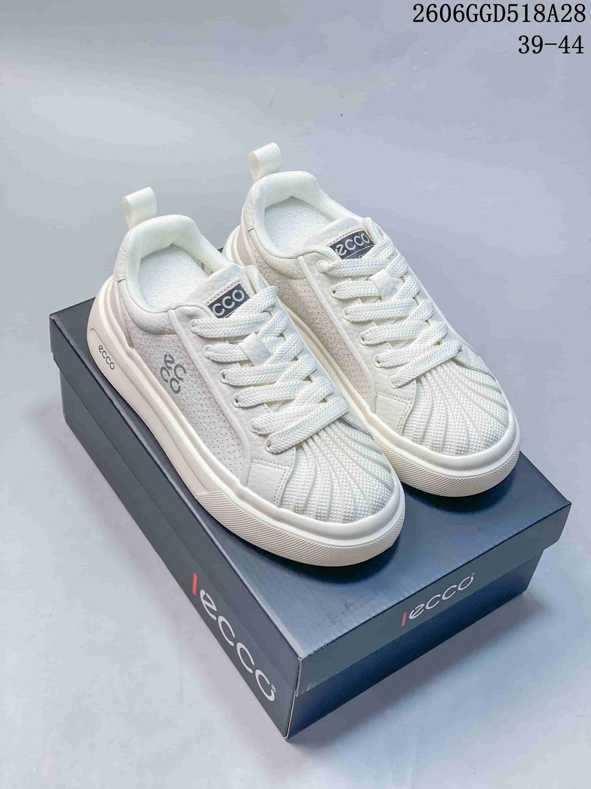 White ECCO lace-up sneakers shown from above on a branded box