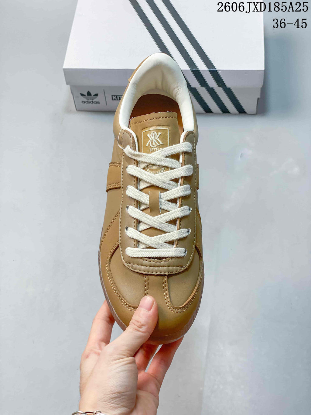 Top view showing the tan upper, white laces, padded collar, and tongue branding.