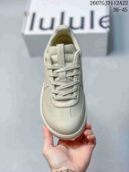 Top view of a light neutral lululemon sneaker showing the lace-up closure, padded tongue and rounded toe.