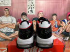 Rear view of white and black Nike basketball sneakers with red accents and visible cushioning.