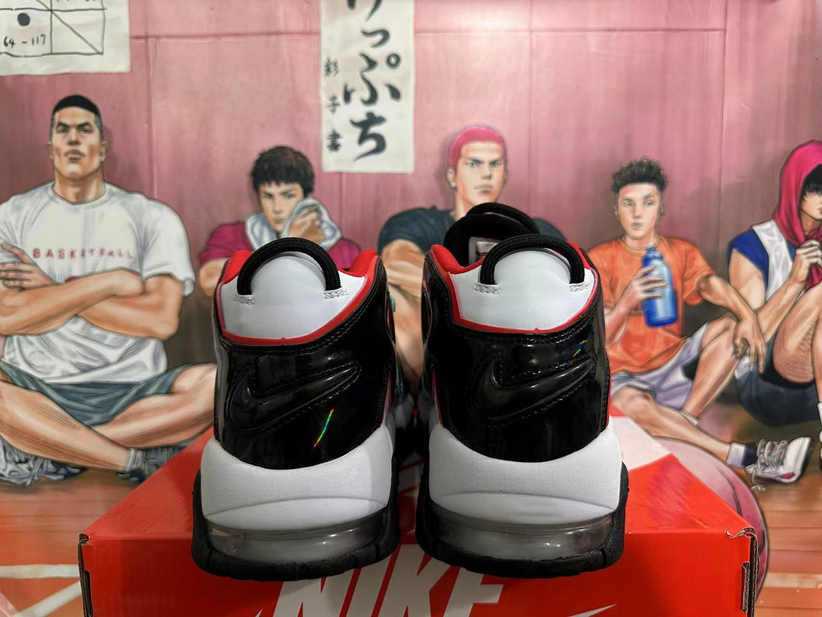 Rear view of white and black Nike basketball sneakers with red accents and visible cushioning.