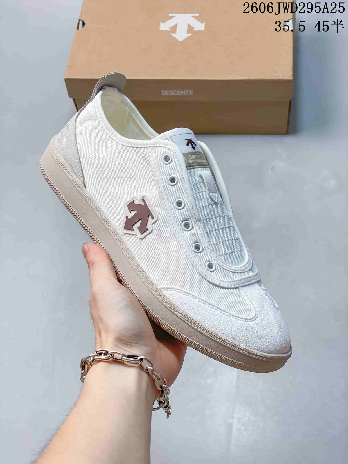 Angled side view of a white and gray DESCENTE sneaker