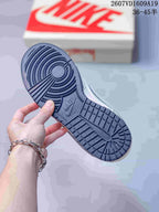 Close-up of the textured navy outsole with concentric circular traction at the forefoot and segmented tread at the heel.