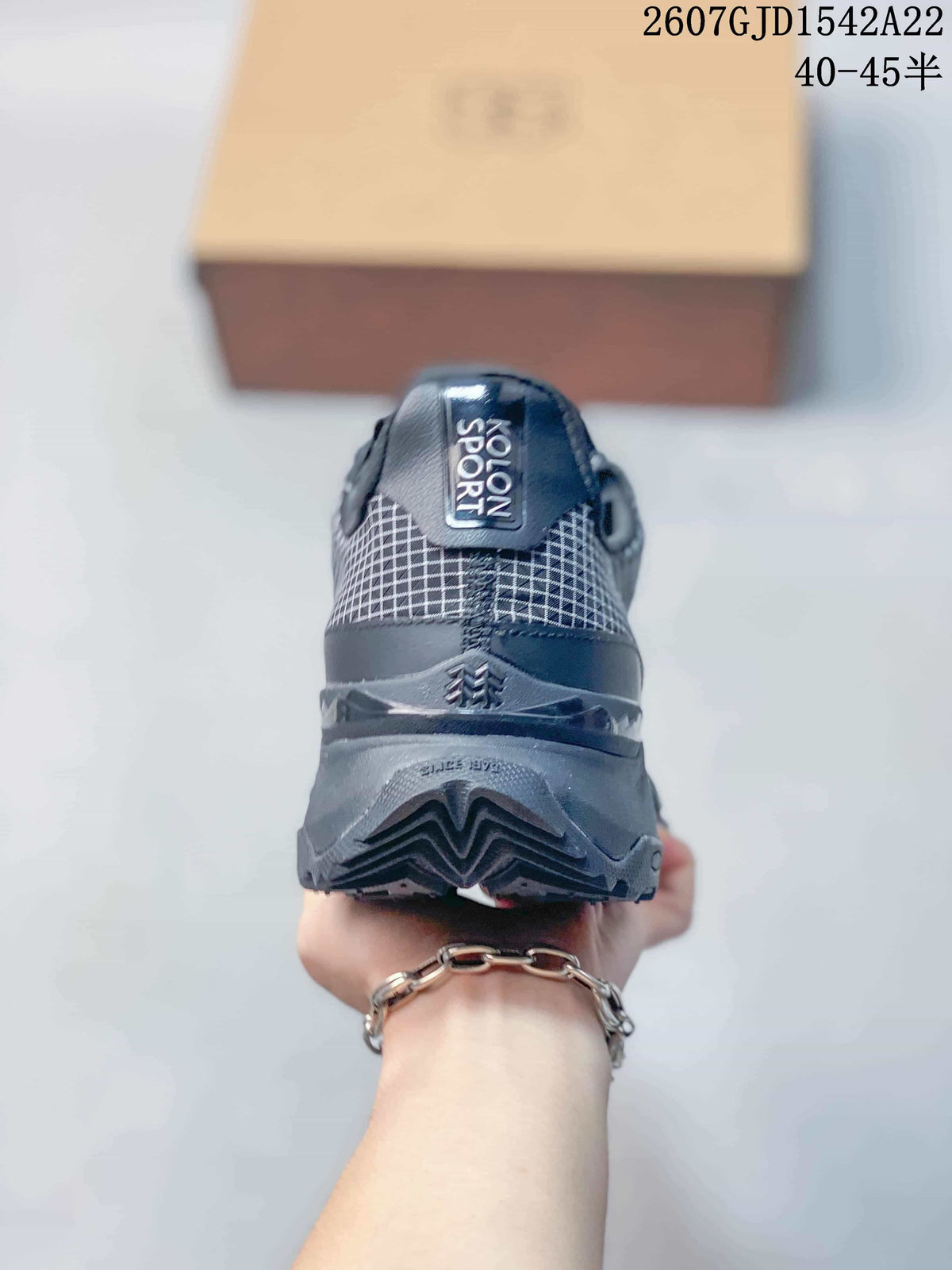 Rear view showing the padded heel, KOLON SPORT heel label and layered lugged outsole.
