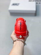 Rear view of the red soccer cleat showing the heel branding and translucent outsole structure.