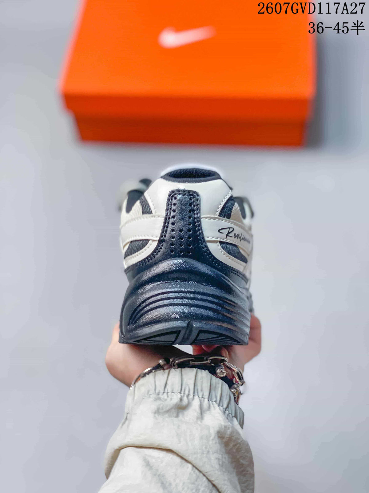 Rear view of a Nike Initiator sneaker showing the padded heel collar, dark heel panel and layered outsole.