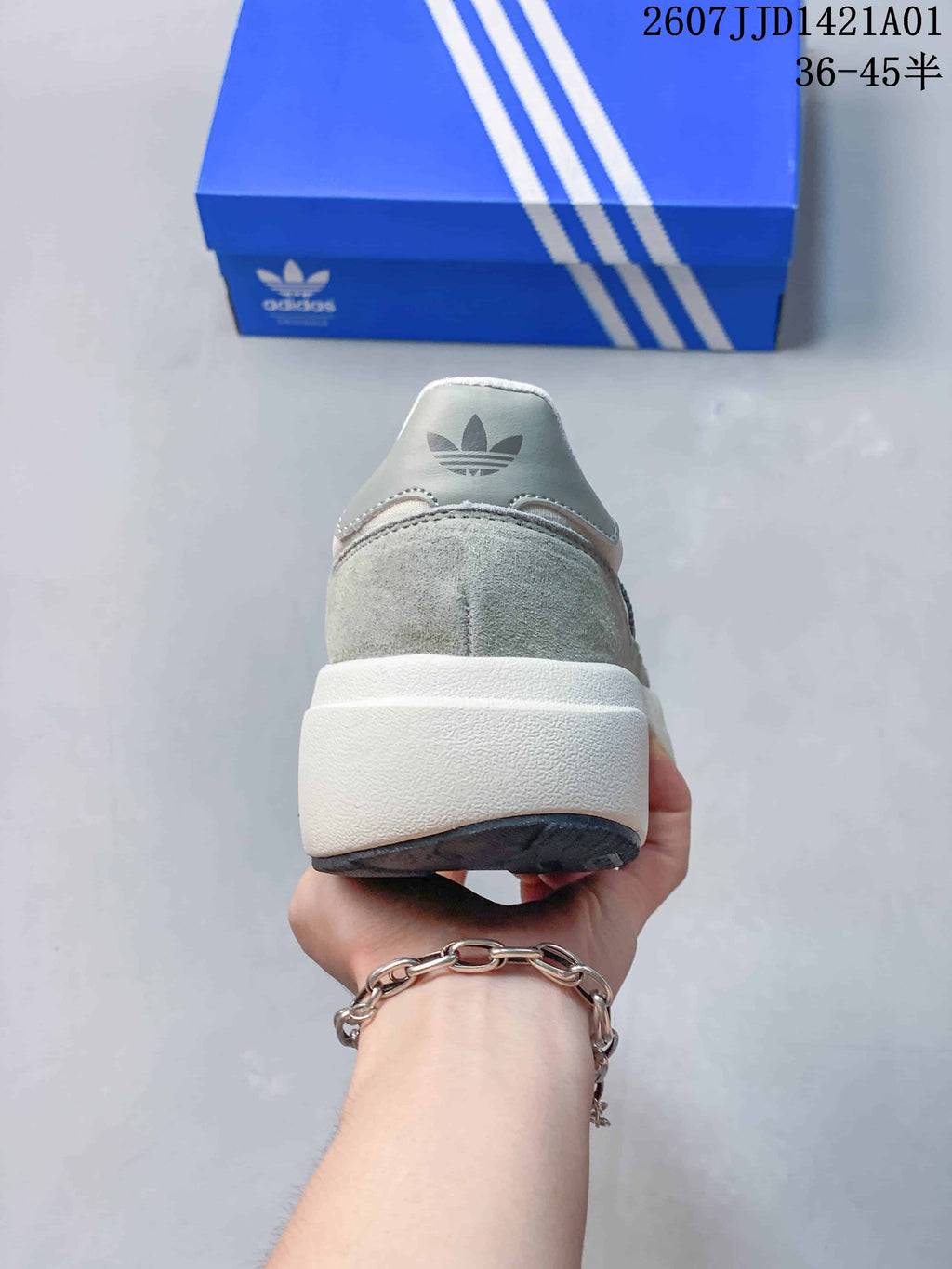 Rear view showing the heel and thick light-colored sole of the Adidas sneaker