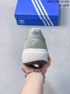 Rear view showing the heel and thick light-colored sole of the Adidas sneaker