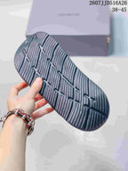 Close-up of the dark gray clog outsole showing a textured, grooved tread pattern.