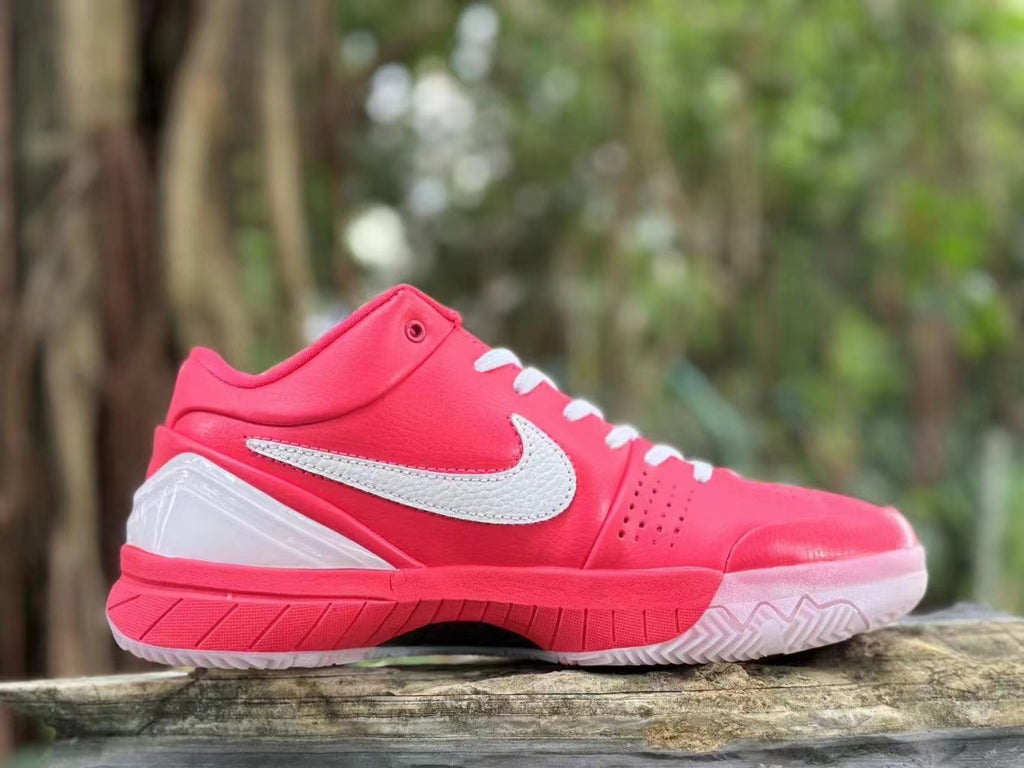 Side profile of a pink Nike Kobe 4 shoe with white Swoosh and translucent outsole.