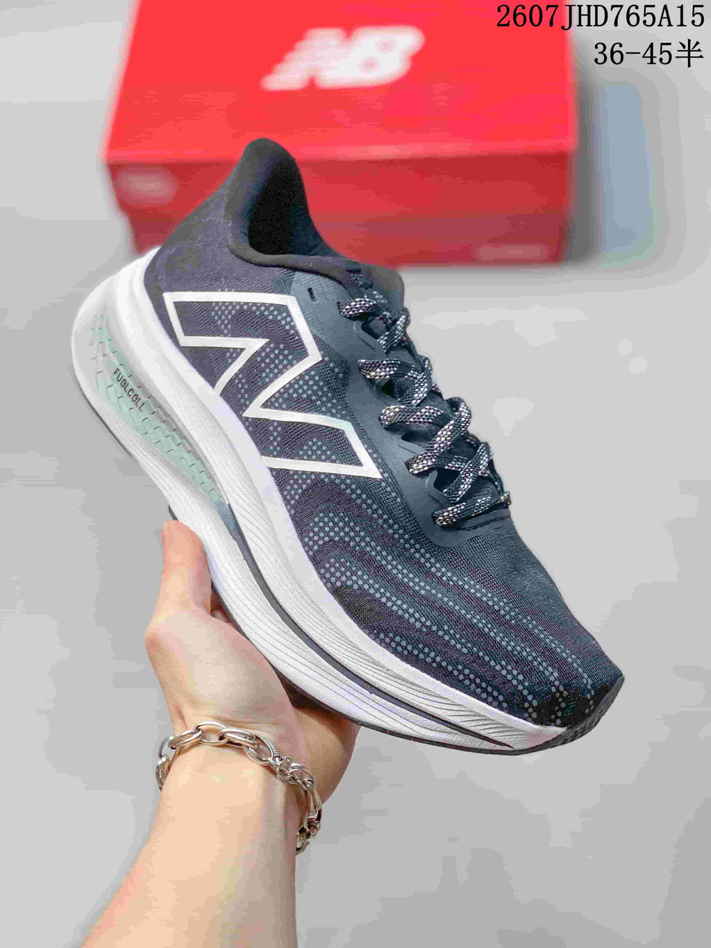 Side view of the running shoe showing the large New Balance logo, patterned upper and white midsole.